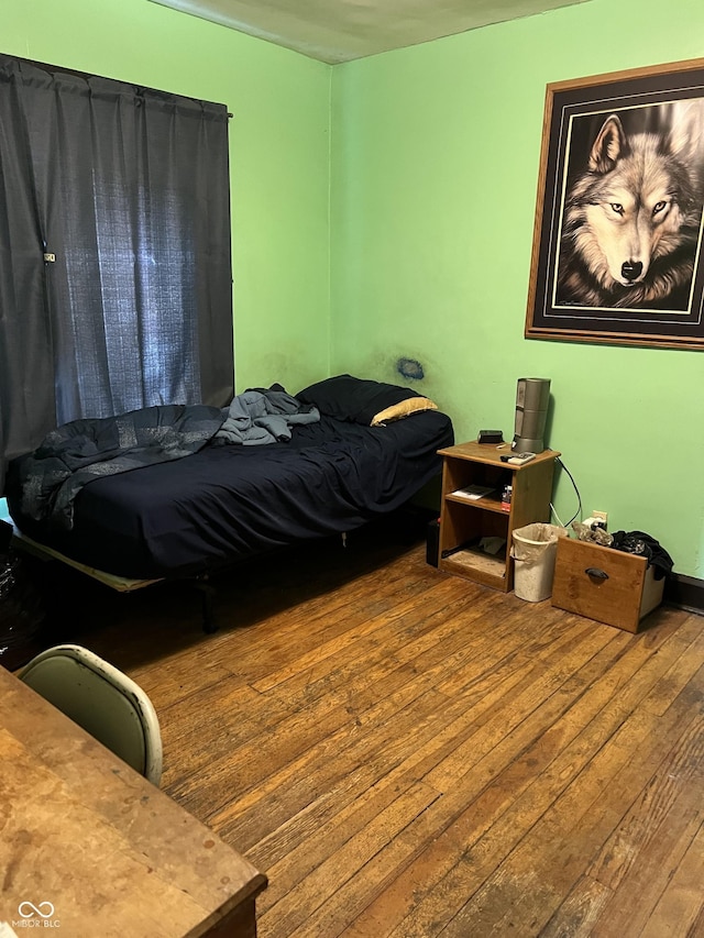 bedroom with hardwood / wood-style flooring