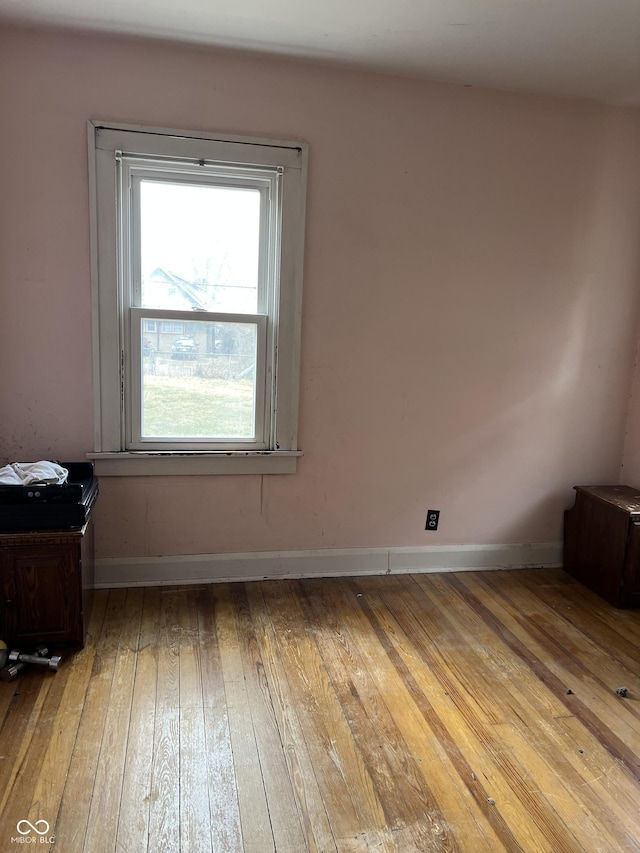 empty room featuring light wood-style flooring and baseboards