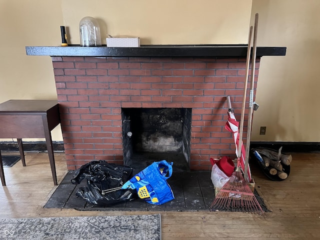 room details featuring a fireplace and wood finished floors