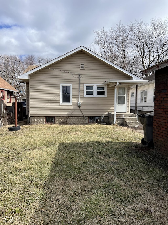 rear view of house with a yard