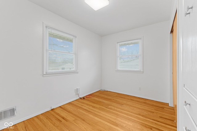 unfurnished bedroom featuring light wood finished floors, visible vents, and baseboards