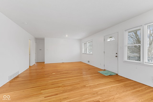 foyer featuring plenty of natural light, light wood-style flooring, and visible vents