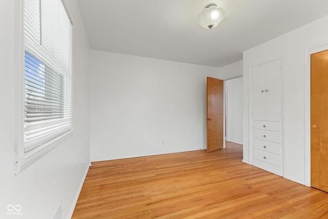 unfurnished bedroom featuring light wood-style floors