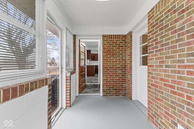 exterior space with brick siding, radiator heating unit, and a porch