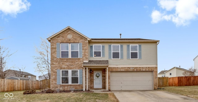 traditional home with concrete driveway, brick siding, and fence