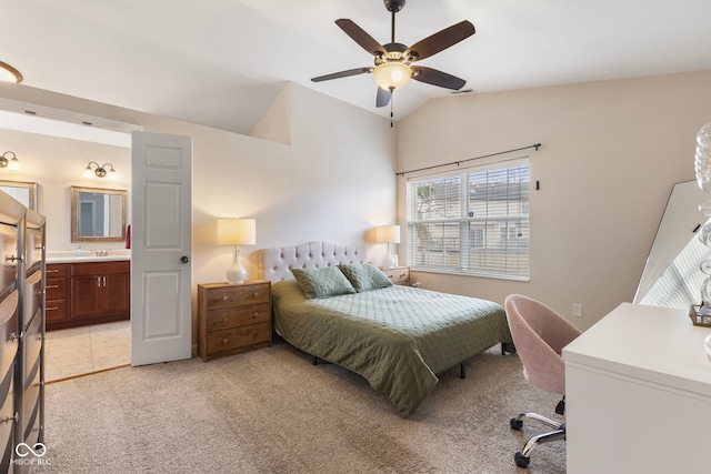 bedroom with a sink, ensuite bath, lofted ceiling, light colored carpet, and ceiling fan