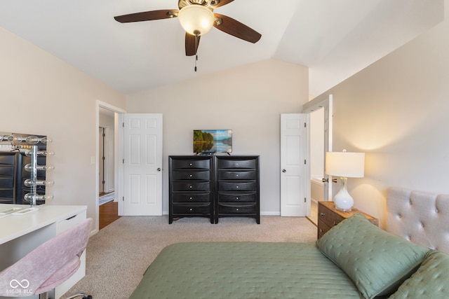 carpeted bedroom with vaulted ceiling, a ceiling fan, and baseboards