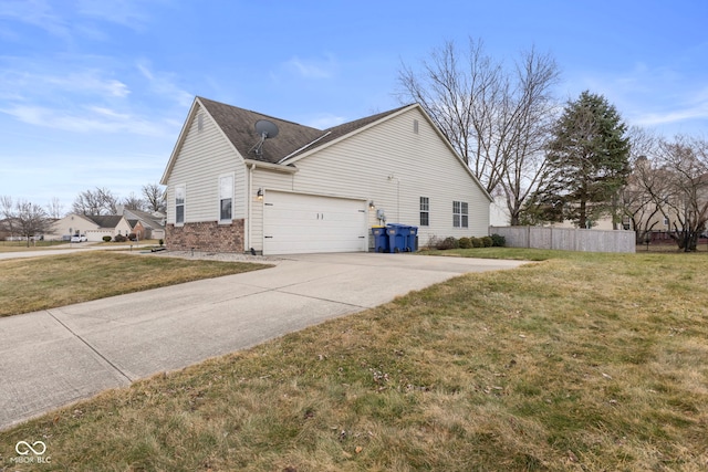 view of side of home with a yard, fence, brick siding, and driveway