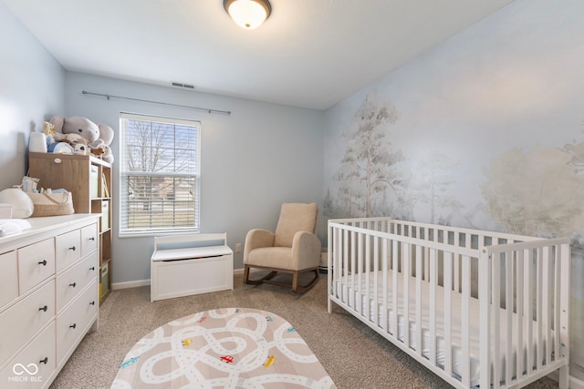 bedroom featuring a nursery area, baseboards, visible vents, and light carpet