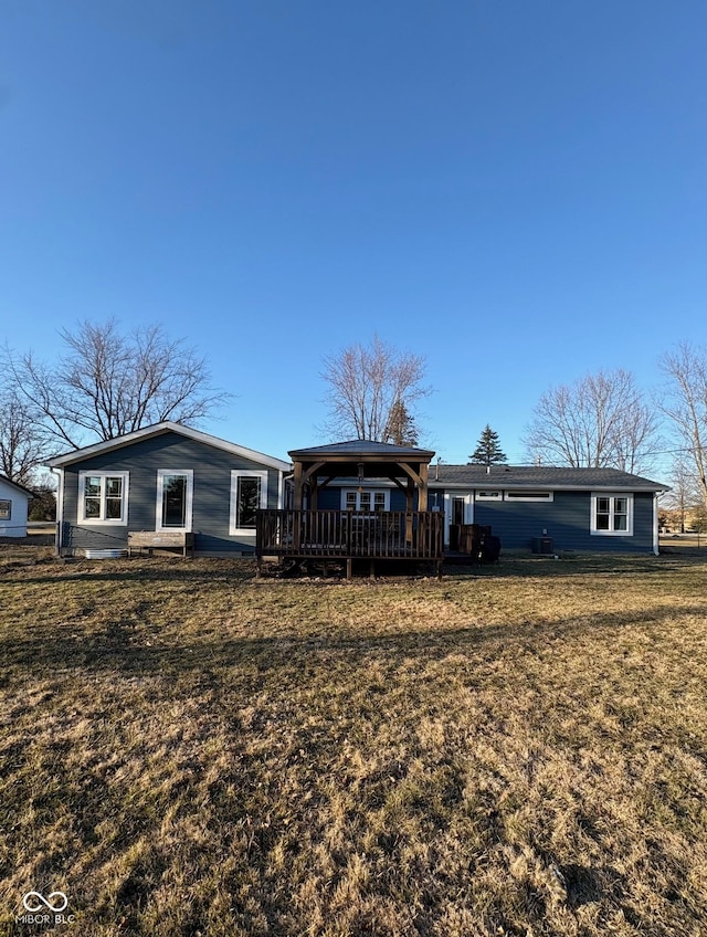 view of front of property featuring a front yard and a wooden deck