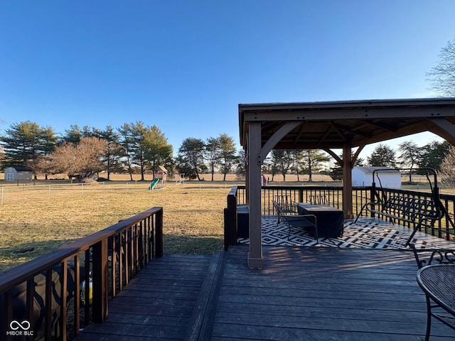 deck with a playground, a yard, and a gazebo