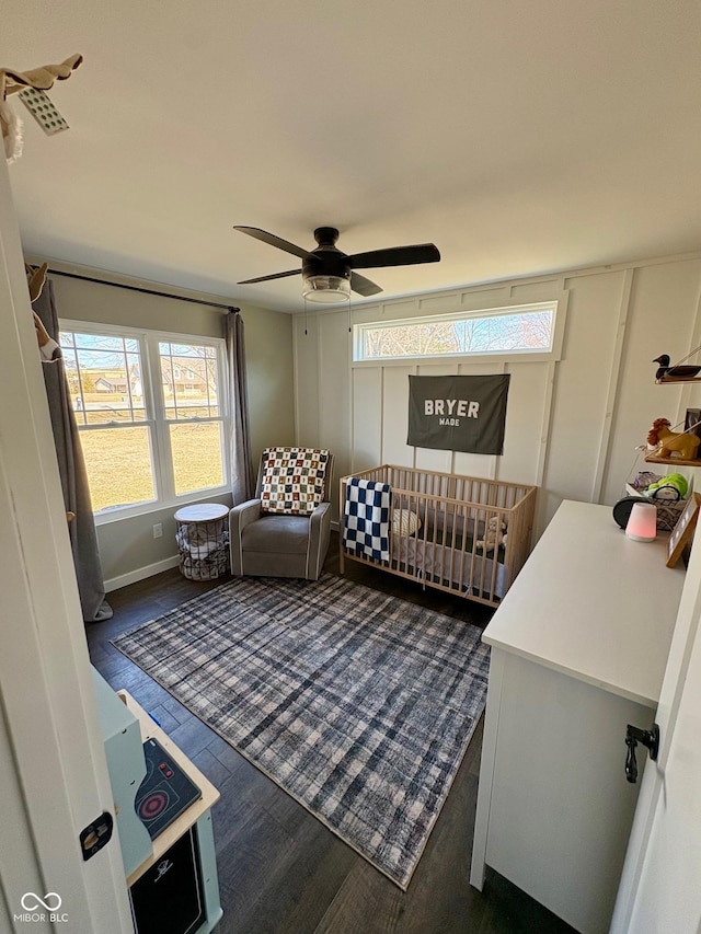 living room featuring ceiling fan and dark wood finished floors