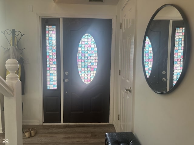 foyer featuring wood finished floors and visible vents