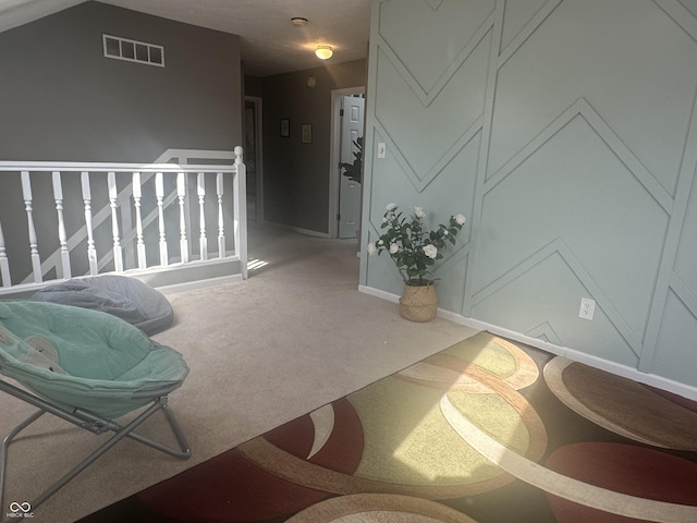 corridor featuring an upstairs landing, baseboards, visible vents, and carpet flooring