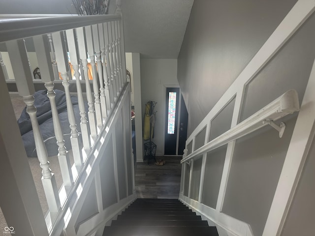 staircase featuring wood finished floors