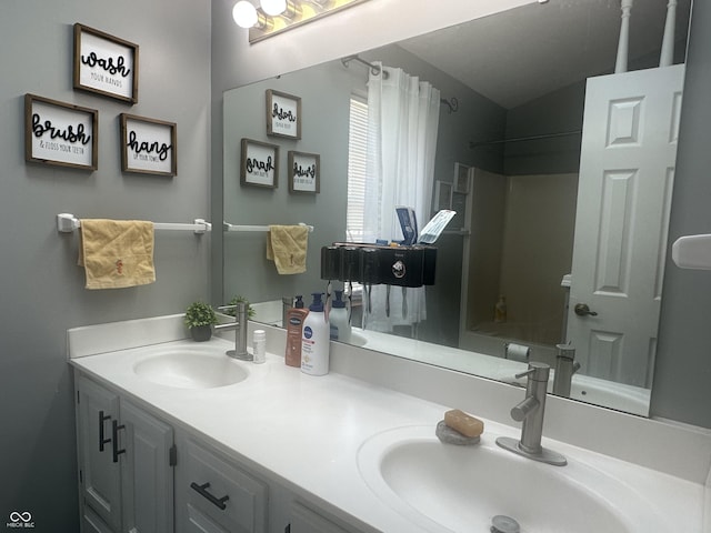 full bath featuring double vanity, bathtub / shower combination, and a sink