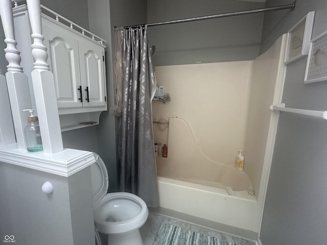 bathroom featuring shower / bath combination with curtain and toilet