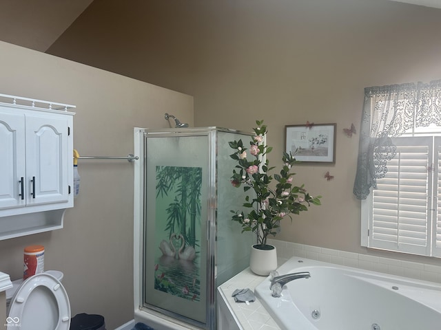 full bathroom with a stall shower, toilet, and a whirlpool tub