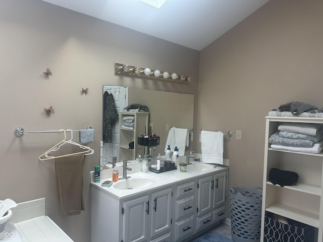 bathroom featuring double vanity and a sink