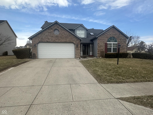 traditional home featuring a garage, a front lawn, concrete driveway, and brick siding