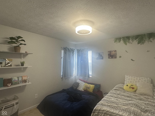 carpeted bedroom with a textured ceiling