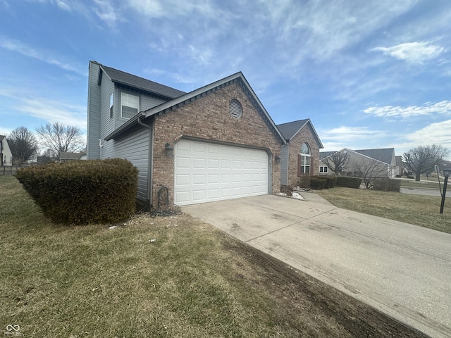 view of side of home featuring a garage, concrete driveway, a lawn, and brick siding