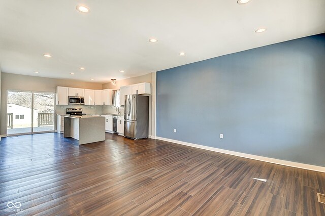 2308 Nowland Ave, Indianapolis, IN 46201 - kitchen with white cabinetry, open floor plan, light countertops, appliances with stainless steel finishes, and dark wood-style floors