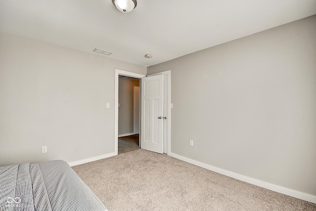 2308 Nowland Ave, Indianapolis, IN 46201 - unfurnished bedroom featuring carpet floors, visible vents, and baseboards