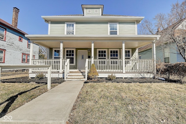 american foursquare style home with covered porch