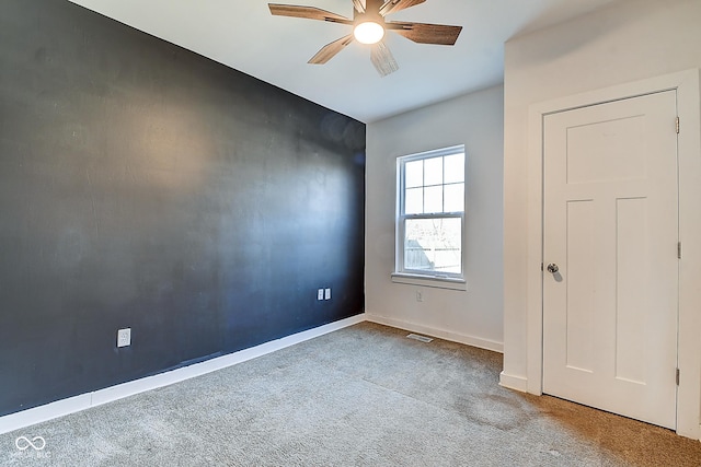 2308 Nowland Ave, Indianapolis, IN 46201 - carpeted empty room with baseboards, visible vents, and a ceiling fan