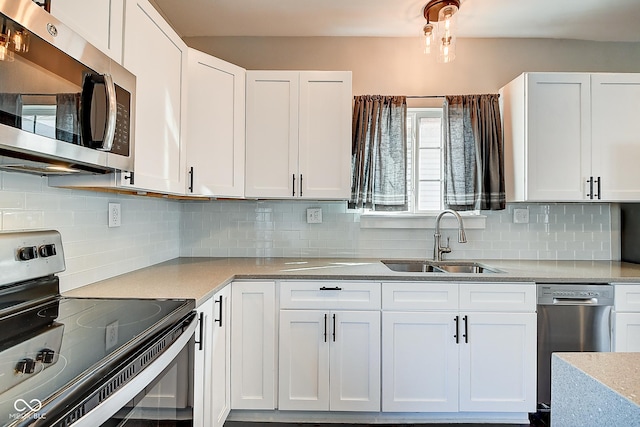 2308 Nowland Ave, Indianapolis, IN 46201 - kitchen featuring stainless steel appliances, light countertops, backsplash, white cabinetry, and a sink