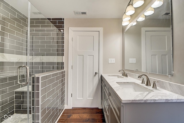 2308 Nowland Ave, Indianapolis, IN 46201 - full bathroom featuring wood finished floors, a stall shower, a sink, and visible vents