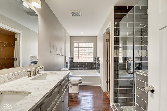 2308 Nowland Ave, Indianapolis, IN 46201 - bathroom featuring toilet, wood finished floors, a sink, visible vents, and double vanity