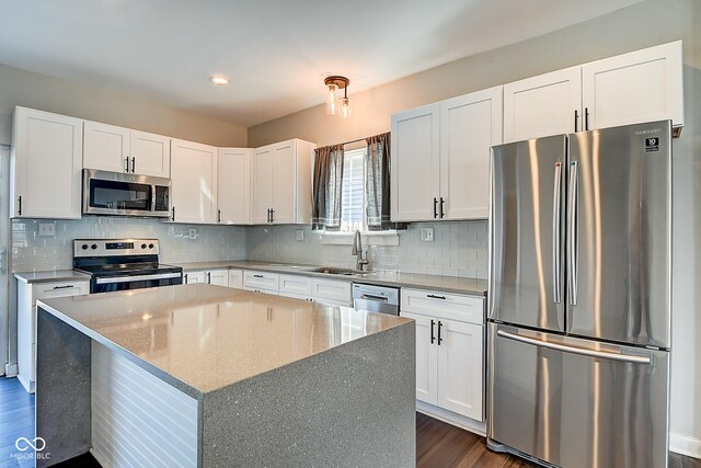 2308 Nowland Ave, Indianapolis, IN 46201 - kitchen featuring dark wood-style floors, stainless steel appliances, tasteful backsplash, and a sink