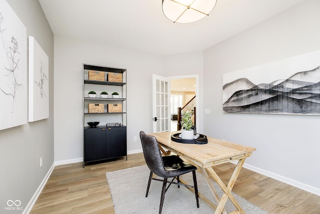 office featuring french doors, baseboards, and light wood finished floors