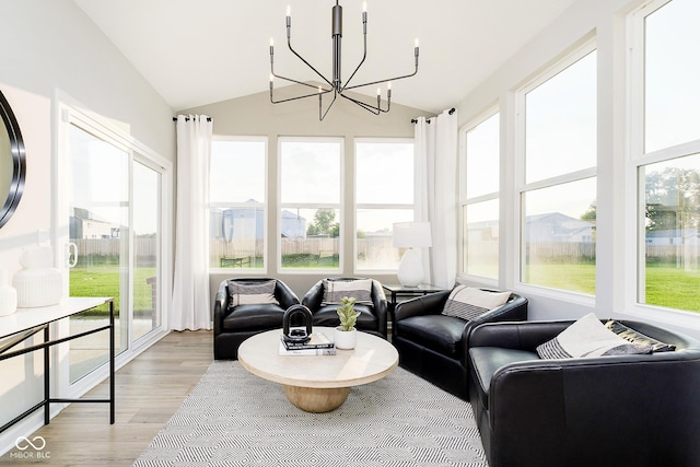 sunroom / solarium featuring a chandelier and lofted ceiling