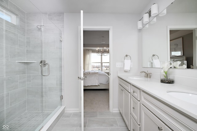 ensuite bathroom featuring a sink, a stall shower, double vanity, and connected bathroom