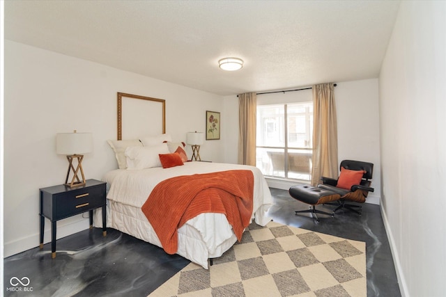 bedroom with finished concrete flooring and baseboards