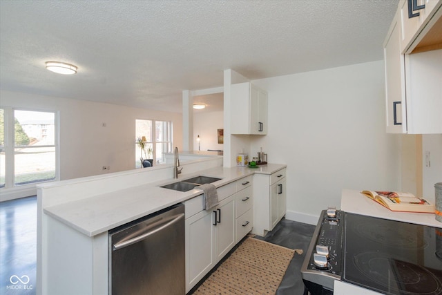 kitchen with a peninsula, a sink, white cabinetry, stainless steel dishwasher, and dark wood-style floors