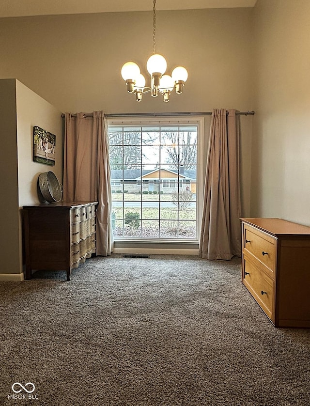 interior space featuring a chandelier and carpet