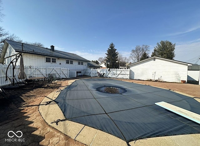 view of swimming pool with a patio area and a fenced backyard