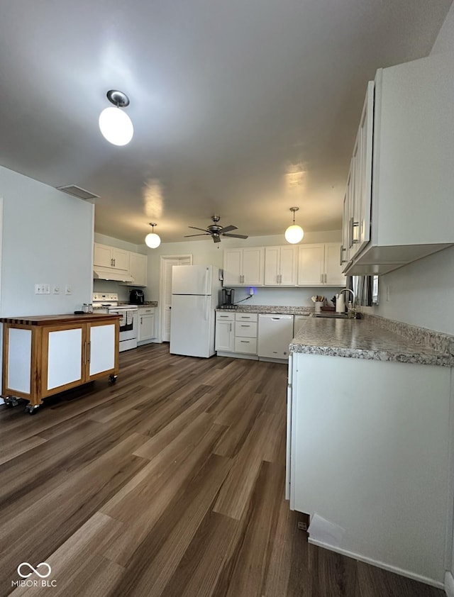 kitchen featuring white appliances, dark wood-style flooring, white cabinets, and a sink