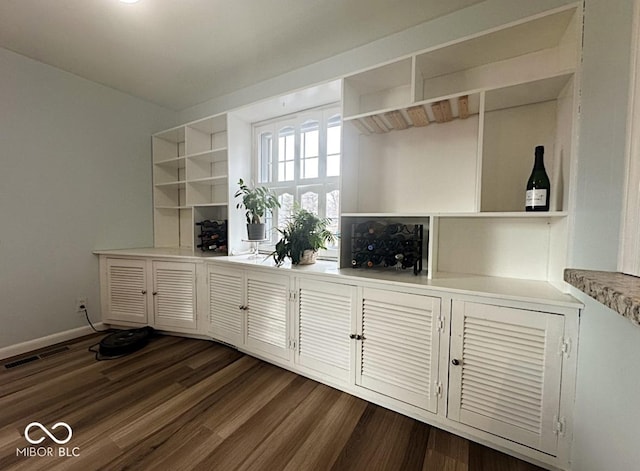 interior details featuring visible vents, baseboards, and wood finished floors