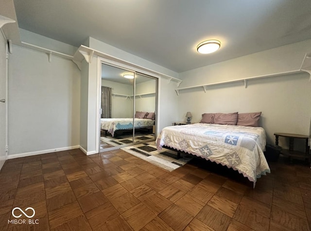 bedroom with baseboards and a closet