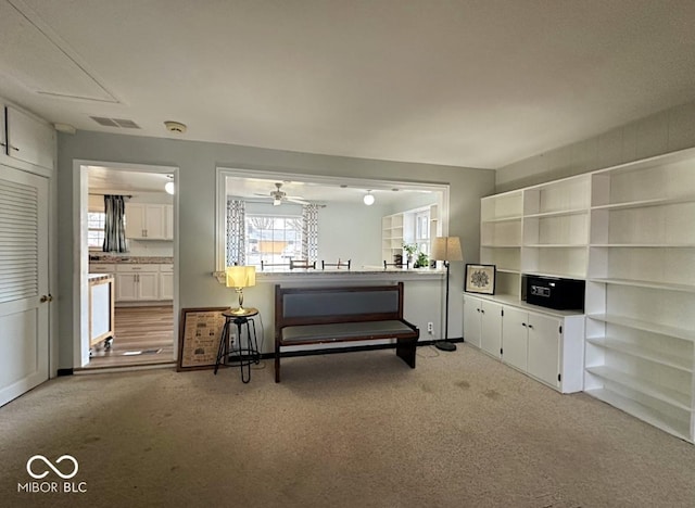 sitting room featuring light carpet and visible vents