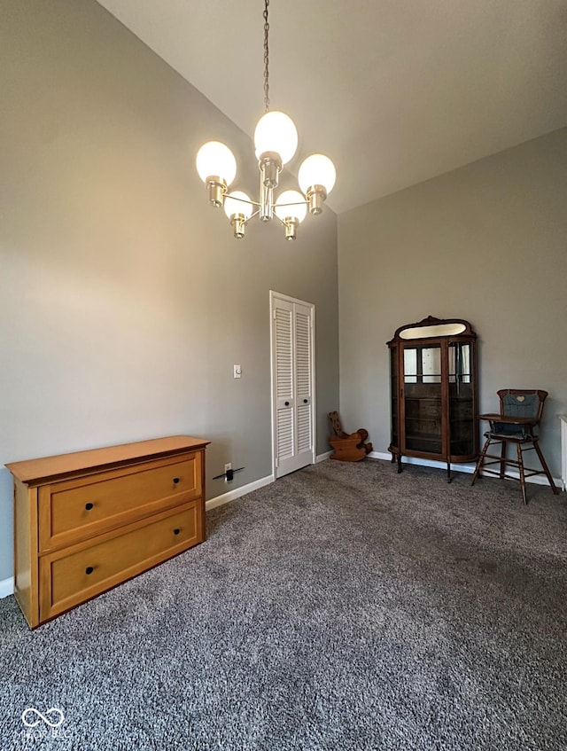 interior space with high vaulted ceiling, dark carpet, baseboards, and an inviting chandelier