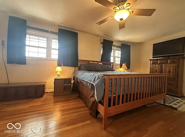 bedroom with wood-type flooring and ceiling fan