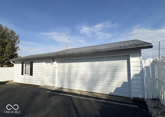 detached garage featuring fence