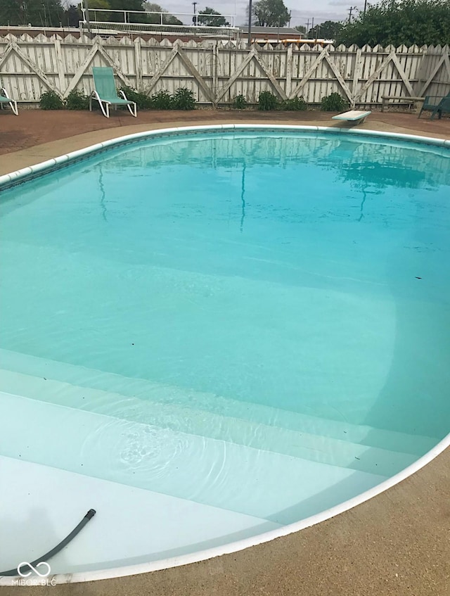1406 Durham Dr, Crawfordsville, IN 47933 - view of swimming pool featuring a fenced backyard, a fenced in pool, and a diving board