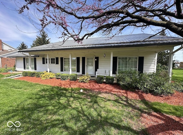 1406 Durham Dr, Crawfordsville, IN 47933 - view of front facade featuring a front lawn, covered porch, and metal roof